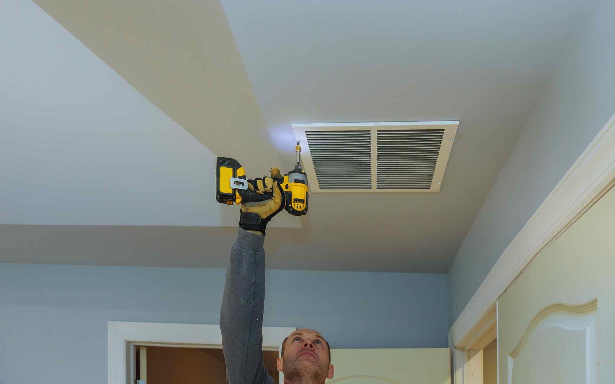 worker-builder-installing-air-conditioner-ventilat-H9X49HH.jpg